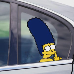 May include: A car window sticker featuring a yellow cartoon character with blue hair, giving the middle finger. The sticker is applied to the window of a silver car. The character's face is visible, with large eyes and a neutral expression.