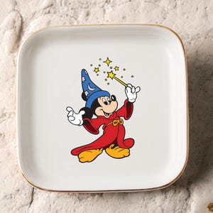 May include: A rustic wooden sign with the text "Welcome" in a handwritten style. The sign is painted white with a distressed finish, and features a decorative floral element. The background is a blurred image of a home.