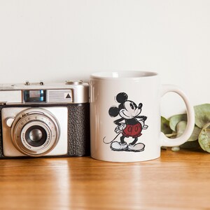 May include: A handmade wooden sign displaying the word "Welcome" in a whimsical font. The white-painted sign has a distressed finish, and is adorned with a floral design in pink and green hues. Suitable for indoor or outdoor display.