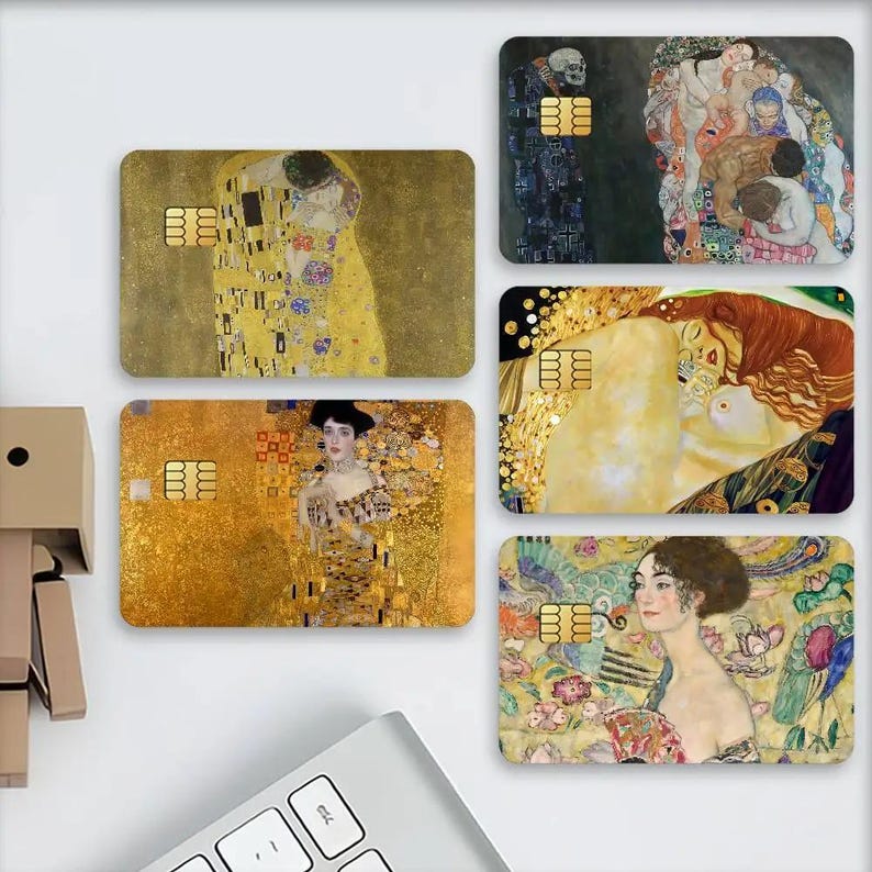 May include: A collection of rectangular cards featuring artwork by Gustav Klimt. The cards display various paintings, including "The Kiss" and portraits, with gold and colorful details. Each card has a gold-colored chip.