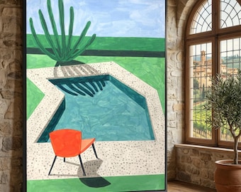 May include: A framed painting depicting a turquoise swimming pool surrounded by a speckled stone patio, a bright orange chair, and a large green agave plant. The scene includes a green lawn and a light blue sky, all enclosed in a black frame.