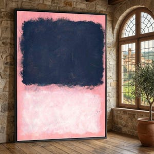 May include: Large framed abstract painting with a dark navy blue rectangular shape at the top and a light pink rectangular shape at the bottom. The painting is displayed in a room with a brick wall and a wooden floor.