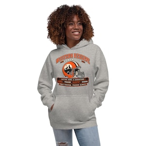 May include: A heather grey hooded sweatshirt featuring a graphic of an orange and brown football helmet with a wolf silhouette. The text reads WESTERN RESERVE LONGHOUSE, NATIVE SONS & DAUGHTERS, MINGO, PENACOOK, BLACKFOOT, KICKAPOO, PALS FOREVER, FRIENDS ALWAYS.