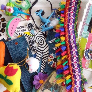 May include: A set of three ceramic canisters with lids, featuring a blue and white floral pattern. The canisters vary in size, with the largest measuring approximately 8 inches in height. They are likely used for kitchen storage.