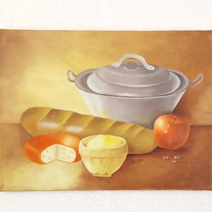 May include: An oil painting of a still life featuring a loaf of bread, a round cheese, a bowl of butter, and a red apple. A large, lidded pot sits behind the food items. The background is a gradient of brown and yellow.