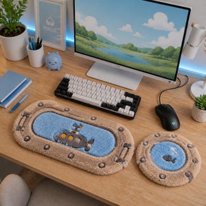 May include: A desktop setup featuring a computer, keyboard, and mouse, with a submarine-themed rug set. The rectangular rug has a submarine design, and the round rug has a fish design. The rugs are beige, blue, and gray.