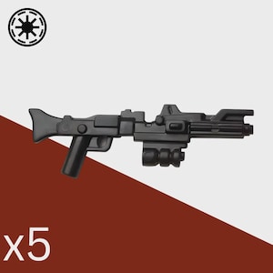 May include: Black plastic toy blaster rifle with a handle, scope, and barrel details. The image includes the text "x5" and a white and black symbol in the upper left corner. The background is white and red.