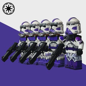 May include: A group of five toy figures, each with a white helmet and purple accents, holding black blasters. The figures are arranged in a row against a purple and white background. The figures are wearing white and purple armor.