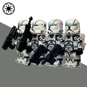 May include: Four white and black action figures with black weapons. The figures have white helmets with blue visors and black detailing. The figures are standing in a row, with the Imperial symbol in the upper left corner.
