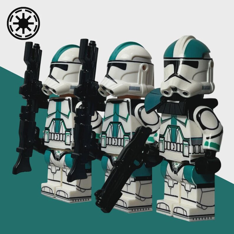 May include: Three white and teal action figures of clone troopers, each holding a black blaster rifle. The figures have white helmets with teal accents and are standing in front of a teal and white background. A black and white symbol is in the upper left corner.
