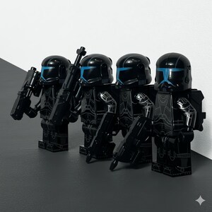 May include: Four black Lego figures in tactical gear, each holding a weapon. The figures have helmets with blue visors and detailed armor. The background is a simple black and white gradient.