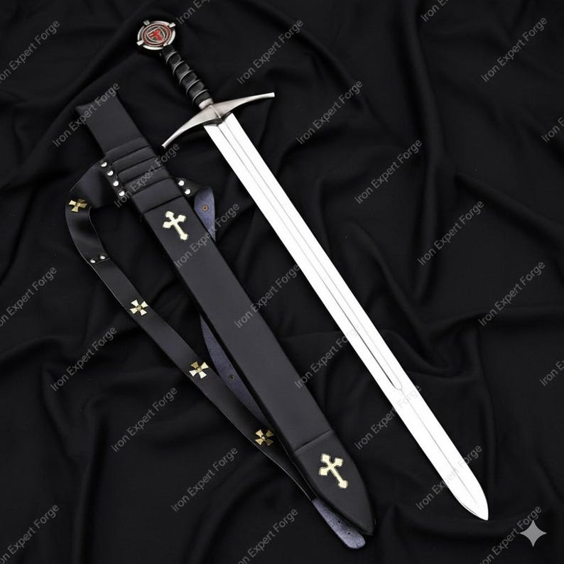 May include: A medieval sword with a silver blade and a black handle, resting in a black leather sheath. The sheath and strap are adorned with gold crosses. The sword's hilt features a red and silver design.