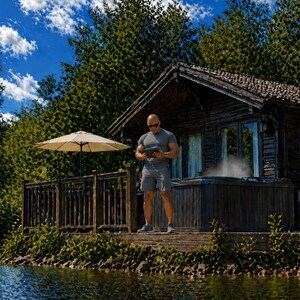 May include: A man in gray athletic wear stands on a wooden deck near a lake, holding a tablet. A small cabin with a hot tub is in the background, with a white umbrella and lush greenery. The sky is blue with fluffy white clouds.
