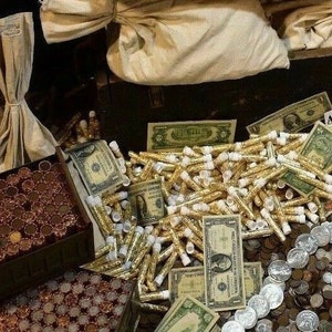 May include: A wooden chest overflowing with gold coins, gold dust, and stacks of US dollar bills. The chest is decorated with a worn, dark brown finish and has a hinged lid. The gold coins are in various denominations and are arranged in rows. The gold dust is in small, clear tubes. The dollar bills are in stacks of various denominations.