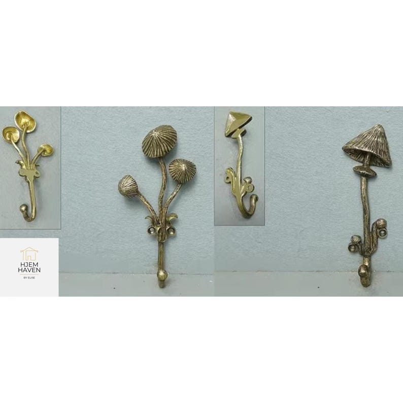May include: Four decorative brass wall hooks in various mushroom designs. Each hook features a unique mushroom cap shape and stem, with intricate detailing. The hooks are mounted on a light blue wall, showcasing their elegant design.
