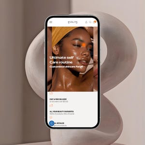 May include: A smartphone displays the "EVALYN" skincare website, featuring a model with radiant skin and the text "Ultimate self Care routine." The site promotes customized skincare. The phone is set against a neutral, abstract background.