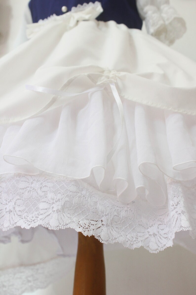 May include: White petticoat with a lace trim and a satin ribbon bow. The petticoat has multiple layers of tulle for volume.