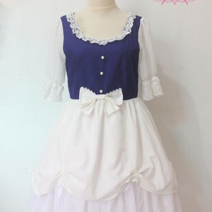 May include: A white and blue dress with a blue bodice and a white skirt. The bodice has a lace neckline and pearl buttons. The skirt has a white bow at the waist and a white lace trim at the bottom.