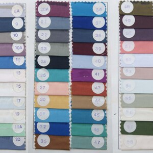 May include: A fabric swatch card displaying 70 different colour swatches. The swatches are arranged in rows and columns, and each swatch is labelled with a number.