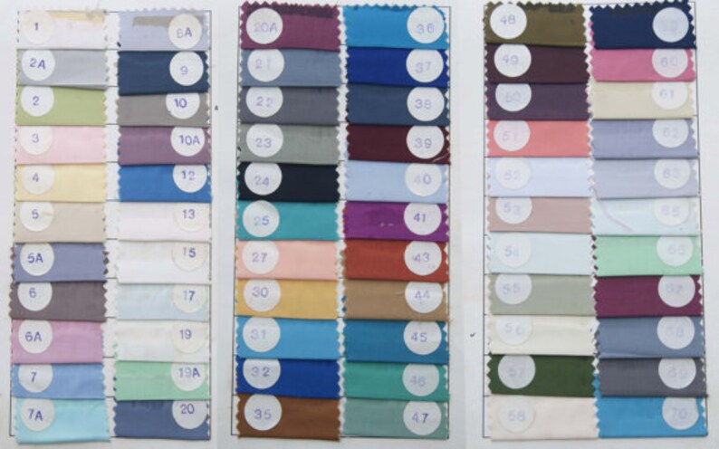 May include: A fabric swatch card displaying 70 different colour swatches. The swatches are arranged in rows and columns, and each swatch is labelled with a number.