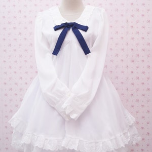 white dress with blue ribbon