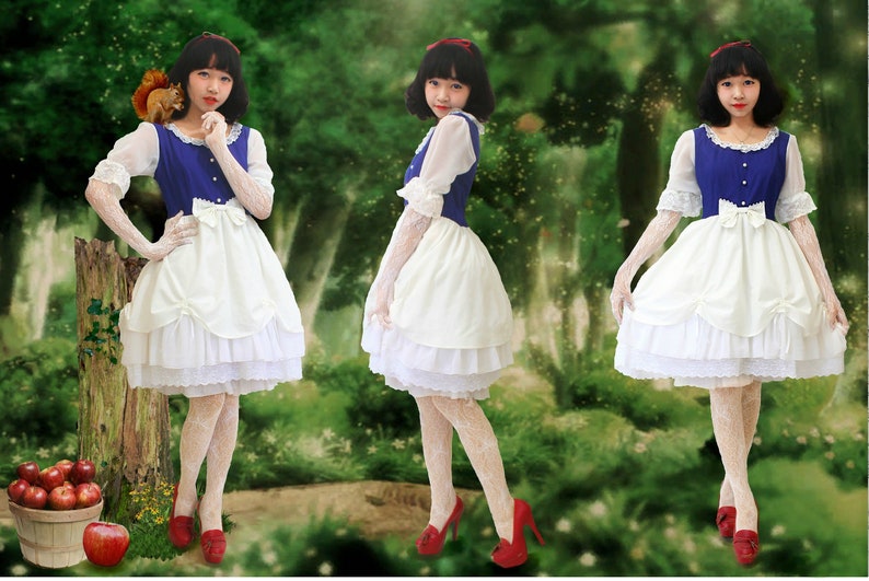 May include: Three women dressed as Snow White in a white dress with a blue bodice and white lace trim. They are wearing white gloves and red shoes. The women are standing in a forest setting.