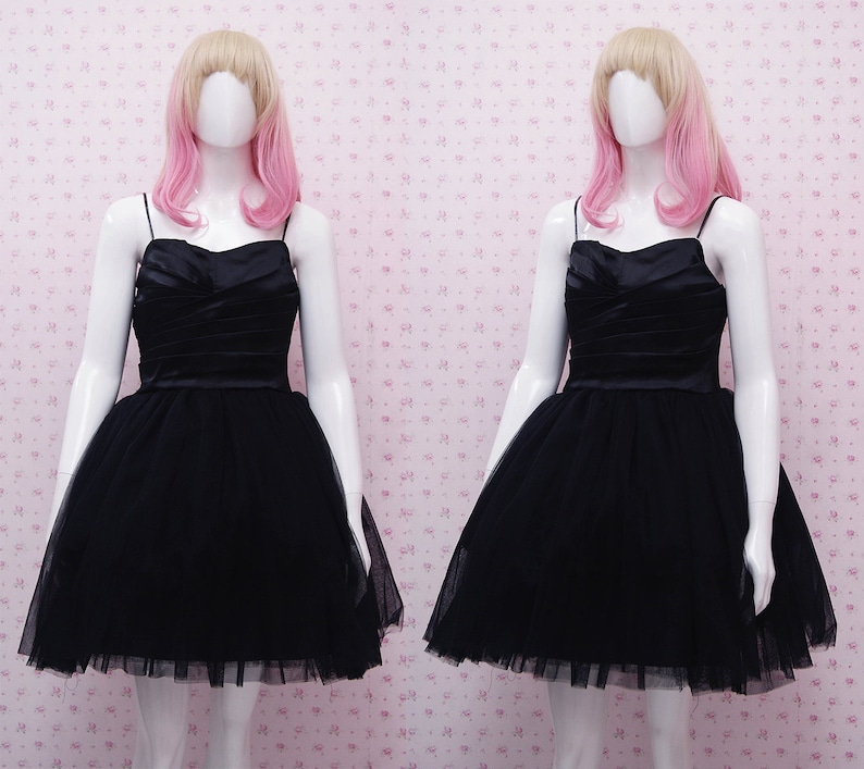 May include: A black tulle dress with a satin bodice and a sweetheart neckline.