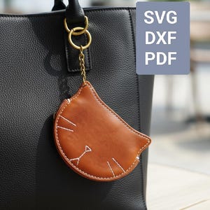 May include: A white ceramic mug with a black handle and the text "But First, Coffee" in a bold, black font. The mug is set against a neutral background, highlighting its simple design.