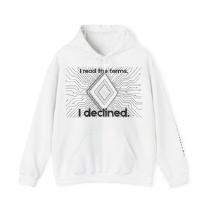 May include: White hoodie with a front pocket and drawstring hood. The front features a black and white graphic of a circuit board design with a diamond shape in the center. The text "I read the terms, I declined" is printed on the front.
