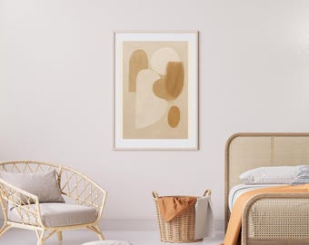 May include: Abstract art print in a light wood frame. The artwork features beige and brown organic shapes on a light beige background. The print hangs above a wicker chair and a woven basket.
