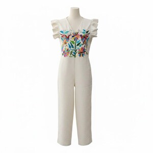May include: An off-white sleeveless jumpsuit featuring a V-neckline and ruffled cap sleeves. The bodice is decorated with a vibrant, multi-coloured floral and bird embroidery pattern. The garment has a straight-leg silhouette and a fitted waist.