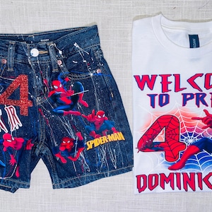 Peut inclure: Un short en jean bleu fonc&eacute; avec des &eacute;claboussures de peinture blanche, un chiffre 4 en paillettes rouges et des motifs Spider-Man, accompagn&eacute; d'un t-shirt blanc avec le texte Welcome to Pre-K, un chiffre 4 rouge, une toile et Spider-Man.