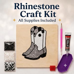 May include: A rhinestone craft kit featuring a square wooden board with a cowboy boot design made of black and white rhinestones. Includes three bags of rhinestones, a pink applicator tool, a tube of B-7000 glue, a purple tray, and a red wax square.