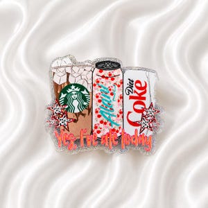 May include: A glittery acrylic badge featuring a Starbucks iced coffee, an Alani Nu energy drink, and a Diet Coke can. The design includes small leopard print stars and the orange text Yes, I've ate today printed across the bottom of the items.
