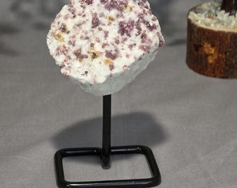 Pink tourmaline specimen on stand