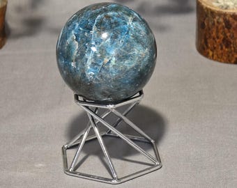 Blue apatite sphere on stand with blue and silver sheen