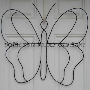 May include: Black metal butterfly shaped wreath, a DIY craft project for decorating a home or garden.