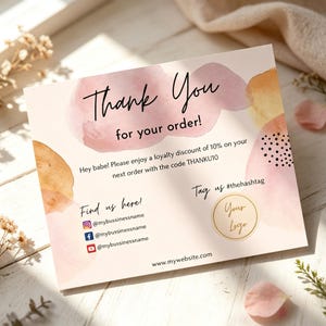 May include: A rectangular thank you card featuring watercolor splashes in pink and orange tones. The text reads Thank You for your order, includes a 10% discount code THANKU10, social media icons with @mybussinessname, a hashtag, and a logo circle.