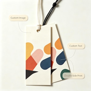 May include: Two rectangular off-white paper tags with rounded corners, each featuring a colorful abstract pattern of yellow, pink, orange, blue, and black shapes. The tags are attached to white and black strings and include labels reading Custom Image, Custom Text, and Double Side Print.