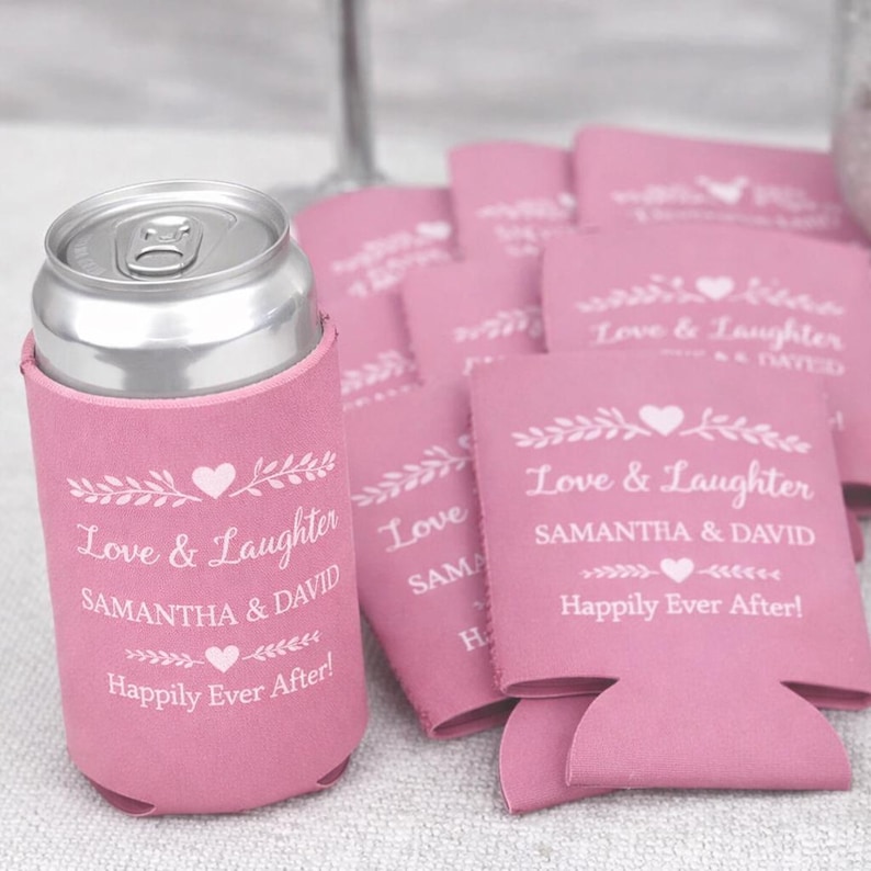 Pink personalized wedding can coolers printed with Love and Laughter theme, couple names, and happily ever after message. A popular choice for romantic weddings, bridal showers, and engagement celebrations. Crafted from quality neoprene for a snug fit on cans and bottles. Designed as reusable favors that enhance table settings and bar displays. Made to order and sold in bulk, these drink sleeves help create a cohesive event aesthetic while giving guests a keepsake they will actually use.
