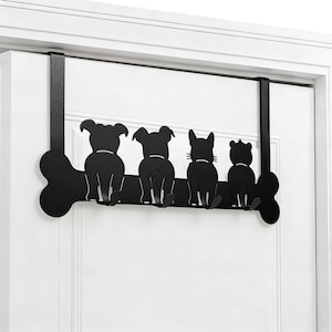 May include: Black metal over-the-door hanger with a dog bone design and four animal silhouettes: two dogs, a cat, and a bear. The figures are sitting, facing away, and are attached to the bone-shaped bar.