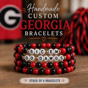 May include: Handmade custom Georgia bracelets. Stack of 4 bracelets with red, black, and white beads. The bracelets spell out "SICEM" and "GODAWGS" with gold accents. The background includes a red and black item and a Georgia Bulldogs logo.