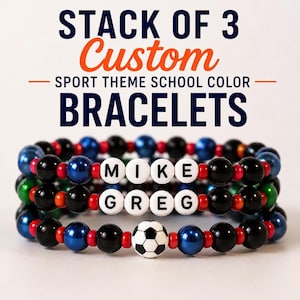 May include: Three custom sport-themed bracelets stacked. Each bracelet features black, blue, red, and green beads. One bracelet has a soccer ball bead. The bracelets spell out "MIKE" and "GREG" with white letter beads. The text above reads "STACK OF 3 Custom SPORT THEME SCHOOL COLOR BRACELETS."