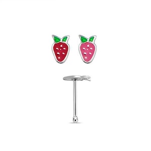May include: A pair of strawberry-shaped stud earrings and a nose stud. The earrings feature a red body with white dots, green leaves, and a silver outline. The nose stud has a silver post with a small ball end.