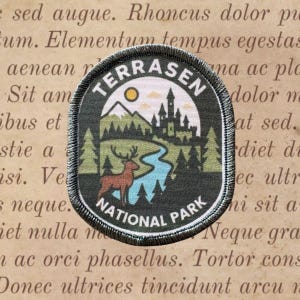 May include: A Terrasen National Park patch with a detailed landscape design. The patch features a deer, river, trees, mountains, and a castle under a yellow sun. The text "TERRASEN NATIONAL PARK" is arched around the top and bottom.