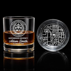 May include: A clear whiskey glass with the Northbridge University logo, name, and graduation year. The glass is filled with amber liquid. A matching coaster with a city map design sits beside it.