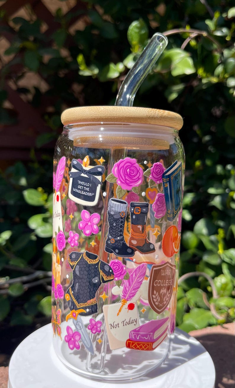 May include: A clear glass tumbler with a bamboo lid and a glass straw. The tumbler is decorated with stickers of pink roses, books, boots, and the text "Should I Get The Wingleader?" and "Not Today".