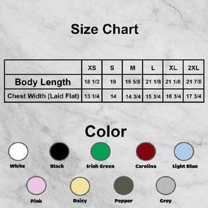 May include: A size chart for clothing, with measurements for body length and chest width in inches. The chart includes sizes XS to 2XL. Color options are displayed, including white, black, Irish green, Carolina, light blue, pink, daisy, pepper, and grey.