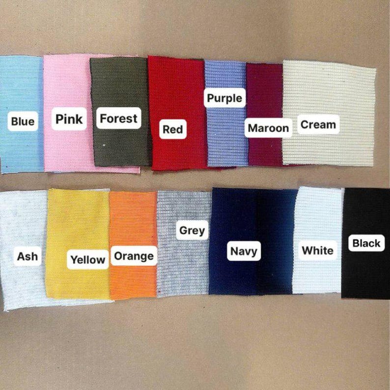 May include: A collection of fabric swatches in various colors, including blue, pink, forest green, red, purple, maroon, cream, ash, yellow, orange, grey, navy, white, and black. Each swatch has a label with its color name.