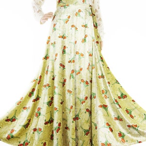 May include: A long, flowing green skirt with a floral print. The skirt has a wrap-around style and is made of a soft, silky fabric.